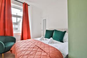 a bedroom with a bed and a chair and a window at Cosy 3-Bedroom House Near Caerphilly Castle in Caerphilly