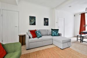 a living room with a couch and a chair at Cosy 3-Bedroom House Near Caerphilly Castle in Caerphilly