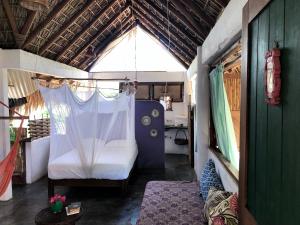 a small room with a bed and a window at Una Posada Mas in Mazunte