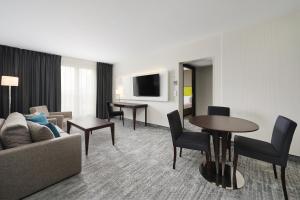 a living room with a couch and a table at Radisson Blu Sobieski in Warsaw