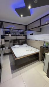 a bedroom with two bunk beds and a desk at Hotel Costa Leste in São Paulo