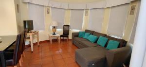 a living room with a couch and a table at Apartamento Parque dos Reis I in Monte Gordo