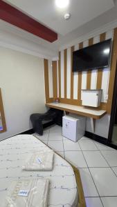 a room with a bed and a flat screen tv at Hotel Costa Leste in São Paulo +14 photos
