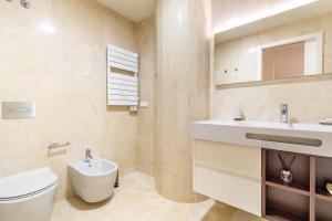 a bathroom with a white toilet and a sink at Douro Porto View in Vila Nova de Gaia +83 photos