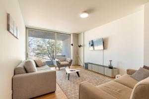 a living room with two couches and a window at Douro Porto View in Vila Nova de Gaia
