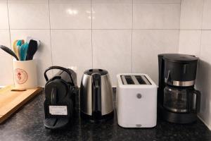 a kitchen counter with a coffee maker and a toaster at Maison calme à Beaune in Beaune