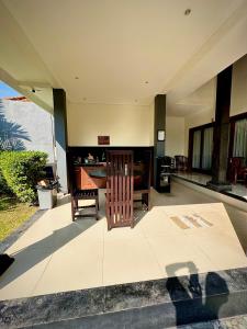 a living room with two chairs and a table at Plawa Bali Guest House in Canggu