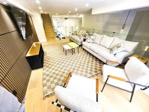 a living room with white couches and chairs at Luxury House with Open Living Space in Toronto