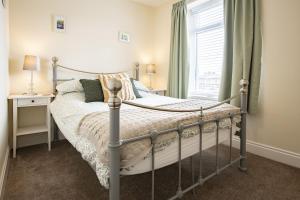 a bedroom with a bed and a window at California Cottage in Barnard Castle