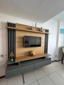 a living room with a television on a wall at Flat 308 - Vista Mar in Salvador