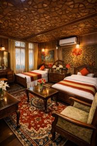 a hotel room with two beds and a table at Imperial Group of Houseboats in Srinagar +10 photos