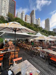 a group of tables and chairs with umbrellas on a deck at Flat 308 - Vista Mar in Salvador