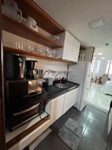 a kitchen with a sink and a microwave at Flat 308 - Vista Mar in Salvador