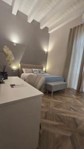 a living room with a bed and a couch at Numistrano Room in Lamezia Terme
