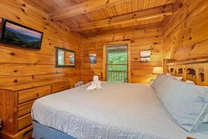 a bedroom with a bed in a log cabin at Getaway Cabin Loft Oasis Mountain View in Gatlinburg +29 photos