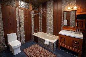 a bathroom with a tub and a toilet and a sink at Imperial Group of Houseboats in Srinagar