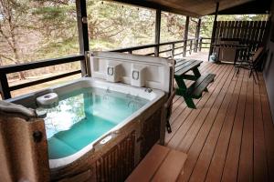 a hot tub on the deck of a house at Blue Jay in South Bloomingville