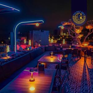 a restaurant with tables and chairs at night at Yaldiz Palace Hotel in Nablus