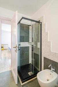 a bathroom with a glass shower and a sink at Villa Afrodite in Mondragone