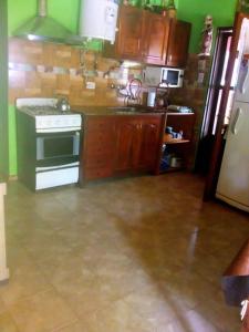 a kitchen with a stove and a sink at Complejo El Tala in Mina Clavero