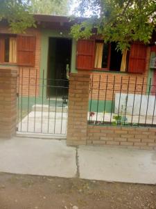 a fence in front of a house at Complejo El Tala in Mina Clavero