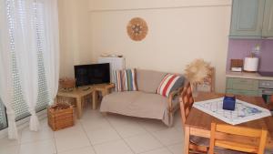 a living room with a couch and a table at EFFIE'S VACATION by the sea in Kanali