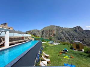 a resort with a pool and mountains in the background at Villa Rokka Luxe - Free Private Heated Pool, Hot Tub, and more in Kissamos