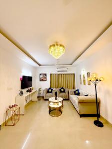 a living room with a couch and a table at Meera Kunj in Chhatikara