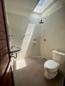 a bathroom with a toilet and a sink at Plawa Bali Guest House in Canggu +7 photos