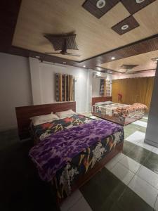 a bedroom with two beds in a room at Hotel Kamla Palace in Haridwār