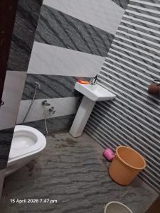 a bathroom with a sink and a toilet at SG Homestay in Amritsar