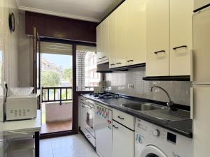 a kitchen with a sink and a washing machine at Apartamento Salceda - 6901 in Noja +9 photos