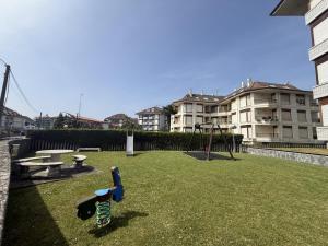 a park with a playground and a swing at Apartamento Salceda - 6901 in Noja