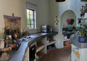 a kitchen with a counter and a stove in it at The Storybook Nook in Kaapsehoop