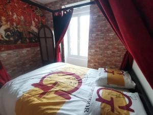 a bedroom with a bed with a cross on it at Appartement dans l'univers Harry Potter in Rosporden