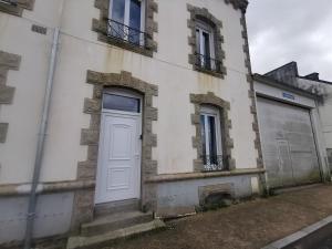 a white door on the side of a building at Appartement dans l'univers Harry Potter in Rosporden