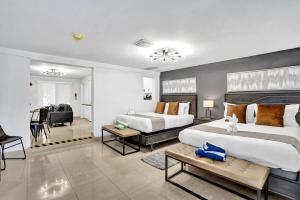a bedroom with two beds and a living room at Beachside Studio w Pool Access Steps from the Shore in Pompano Beach +18 photos