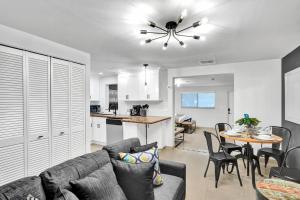 a living room and kitchen with a couch and a table at Beachside Studio w Pool Access Steps from the Shore in Pompano Beach