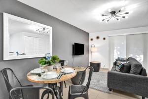 a living room with a table and a couch at Beachside Studio w Pool Access Steps from the Shore in Pompano Beach