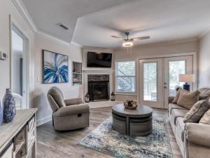 a living room with a couch and a table at Tranquility Skies MTN View Sauna Jacuzzi MORE in Gatlinburg