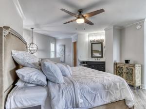 a bedroom with a bed with a ceiling fan at Tranquility Skies MTN View Sauna Jacuzzi MORE in Gatlinburg