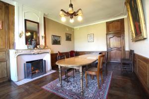 a dining room with a table and a fireplace at Chambre n2 Maison dHôtes de Charme in Maizières