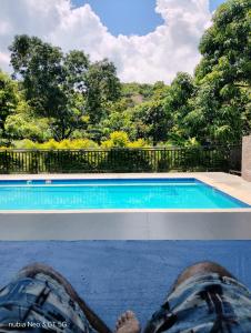 a person is sitting next to a swimming pool at San Alejo in San Joaquín