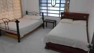 a bedroom with two beds and a window at San Alejo in San Joaquín
