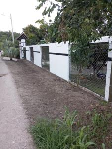 a white fence next to a dirt road at San Alejo in San Joaquín