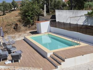 a swimming pool on a patio next to a house at Luar de Prata by Portus Alacer in Crato