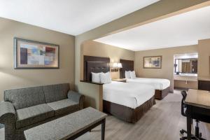 a hotel room with two beds and a couch at Best Western Lumberton in Lumberton +26 photos
