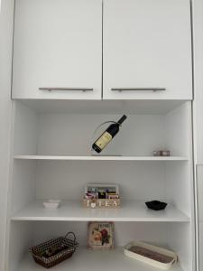 a white shelf with a bottle on top of it at Apartman MARIJA in Pale +5 photos