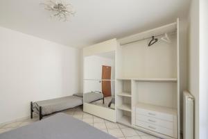 a bedroom with a bed and a large closet at Alba sul Mare Apartment in Campofilone