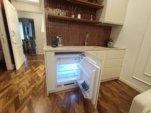 an empty refrigerator in the middle of a kitchen at Aria Domus in Lastra a Signa